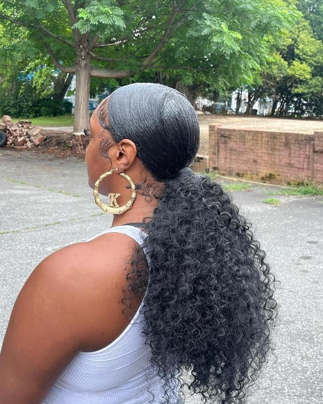 sleek low curly ponytail with weave